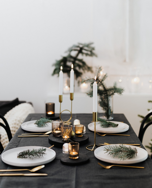 Holiday table setting with black tablecloth